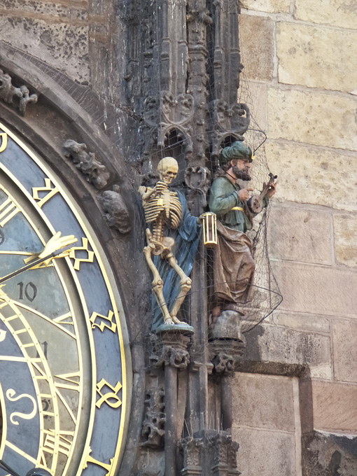 Skeleton and Musician Statues on Clock Tower